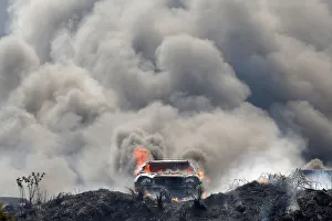 Smoke billows from burning cars during a fire at a plot where police kept seized vehicles Smoke billows from burning cars during a fire at a plot where police kept seized vehicles