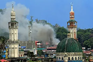 Smoke billows are seen as government troops continue their assault against insurgents Smoke billows are seen as government troops continue their assault against insurgents