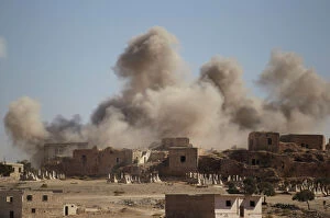 Images Dated 25th September 2016: Smoke rises behind the ancient castle of the rebel-controlled town of Maaret al-Numan