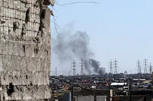 Smoke is seen as members of the Iraqi forces clash with Islamic State fighters on a Smoke is seen as members of the Iraqi forces clash with Islamic State fighters on a