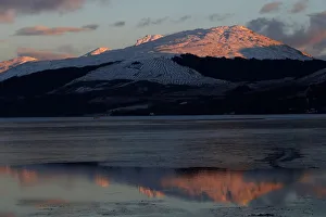 Snow capped mountains are reflected in Loch Fyne, as seen from Inveraray, Scotland Snow capped mountains are reflected in Loch Fyne, as seen from Inveraray, Scotland
