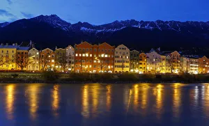 The snow covered mountain summits of Nordkette mountains are seen behind the city The snow covered mountain summits of Nordkette mountains are seen behind the city