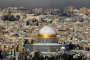 Gold Colour Gallery: Snow covers the Dome of the Rock on the compound known to Muslims as al-Haram al-Sharif
