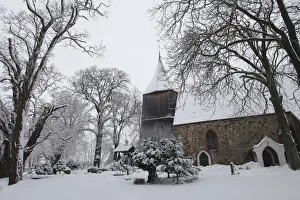 Snow covers the trees in the cemetery of a church in the village of Dersekow in northern Snow covers the trees in the cemetery of a church in the village of Dersekow in northern