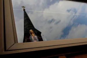 Statuette of Virgin Mary is seen inside of a house in front of Charles Borromeo Parish Statuette of Virgin Mary is seen inside of a house in front of Charles Borromeo Parish
