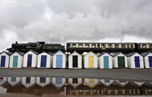A steam train passes beach huts on Goodrington Sands in Paignton A steam train passes beach huts on Goodrington Sands in Paignton
