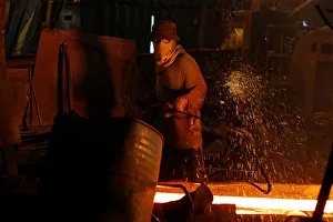 A steelworker is seen in a mill in Chau Khe village outside Hanoi A steelworker is seen in a mill in Chau Khe village outside Hanoi