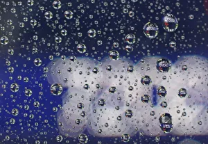 Stock prices displayed on an electronic board are reflected on raindrops on the window of Stock prices displayed on an electronic board are reflected on raindrops on the window of