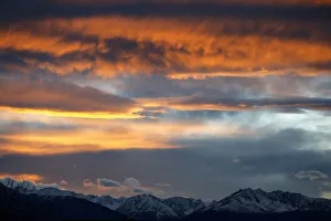 The summits of snow covered mountains are silhouetted during sunset in Innsbruck The summits of snow covered mountains are silhouetted during sunset in Innsbruck