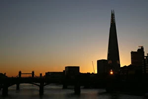 Images Dated 14th January 2016: The sun is seen through a window of the Shard building during sunrise in central London