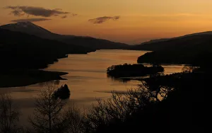 The sun sets over Loch Tummel seen from Queens View in Perthshire, Scotland The sun sets over Loch Tummel seen from Queens View in Perthshire, Scotland
