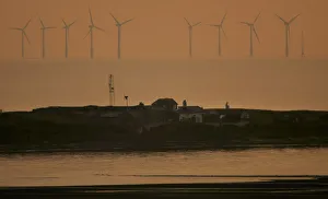 The sun sets behind the North Hoyle offshore wind farm The sun sets behind the North Hoyle offshore wind farm