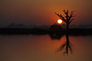 The sun sets over Taungthaman Lake in Amarapura near Mandalay The sun sets over Taungthaman Lake in Amarapura near Mandalay