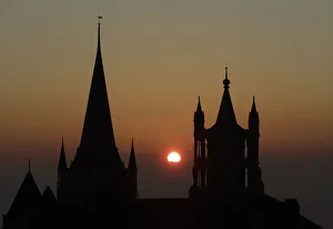 The sun sets on a winter evening between the spires of the Cathedral of Notre Dame in The sun sets on a winter evening between the spires of the Cathedral of Notre Dame in
