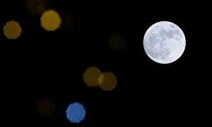 A supermoon full moon is seen through Christmas lights in Harpenden A supermoon full moon is seen through Christmas lights in Harpenden