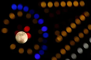 The supermoon full moon is seen through Christmas lights in Valletta The supermoon full moon is seen through Christmas lights in Valletta