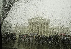 The Supreme Court is seen from within a car as snow melts on the window during a light The Supreme Court is seen from within a car as snow melts on the window during a light