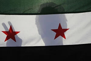 Images Dated 14th June 2012: A Syrian protester holds a Syrian opposition flag during a demonstration