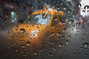 A taxi is pictured through the window of another taxi in the rain in Times Square A taxi is pictured through the window of another taxi in the rain in Times Square