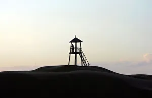 Tourist stands in kiosk used to overlook a park in Tengeri Desert Tourist stands in kiosk used to overlook a park in Tengeri Desert