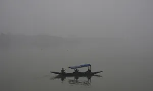 Tourists take a boat ride amid heavy fog at Sukhana Lake in Chandigarh Tourists take a boat ride amid heavy fog at Sukhana Lake in Chandigarh