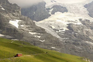Images Dated 27th July 2012: Tourists leave a train of the Jungfraubahn railways at the Kleine Scheidegg station