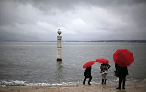 Tourists visit the Cais das Colunas in front of the Tagus River in Lisbon Tourists visit the Cais das Colunas in front of the Tagus River in Lisbon