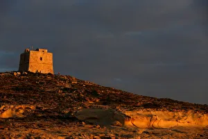 Tourists walk near Dwejra Tower, a watchtower built in 1652 Tourists walk near Dwejra Tower, a watchtower built in 1652