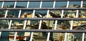 DOWN TOWN LISBON IS REFLECTED ON THE WINDOWS OF A MODERN BUILDING DOWN TOWN LISBON IS REFLECTED ON THE WINDOWS OF A MODERN BUILDING