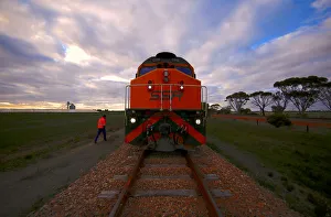 Train driver Gavin Slater inspects the track as he prepares to climb into the driver's Train driver Gavin Slater inspects the track as he prepares to climb into the driver's
