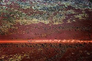 A truck drives along a dirt road in the Pilbara region of Western Australia A truck drives along a dirt road in the Pilbara region of Western Australia
