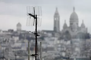 Rooftops Gallery: A tv antenna is seen on the rooftops of residential buildings in front of the Sacre Coeur