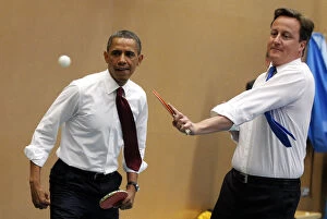 World Leaders Gallery: U.S. President Barack Obama plays table tennis against students with British Prime