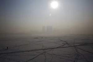 A view of Harbin surrounded by fog is seen over the frozen Songhua River in the northern A view of Harbin surrounded by fog is seen over the frozen Songhua River in the northern
