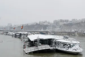 A view shows snow-covered peniche boats moored along the flooded banks of the River Seine A view shows snow-covered peniche boats moored along the flooded banks of the River Seine