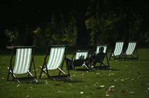 Images Dated 30th September 2014: Visitors enjoy the autumn sunshine as they sit in deck chairs in St James Park, central