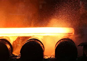 Water and steam fly off of a slab of steel rolls down the line at the Novolipetsk Steel Water and steam fly off of a slab of steel rolls down the line at the Novolipetsk Steel