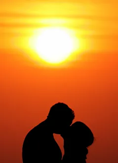 Indonesia Gallery: Western tourists kiss during sunset in Bali