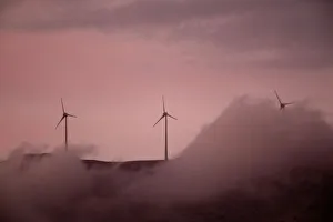 Wind turbines operate atop a mountain during sunset near the town of Kalavrita Wind turbines operate atop a mountain during sunset near the town of Kalavrita