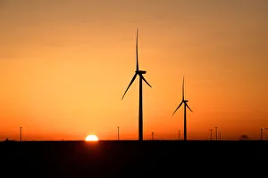 Wind turbines operate at sunrise in the Permian Basin oil Wind turbines operate at sunrise in the Permian Basin oil