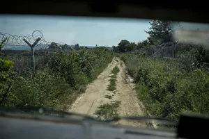 A wire fence is seen from an army vehicle as Macedonian soldiers patrol at the A wire fence is seen from an army vehicle as Macedonian soldiers patrol at the