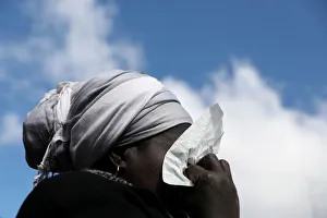 A woman cries as she attends a gathering to protest the death of a street hawker in A woman cries as she attends a gathering to protest the death of a street hawker in