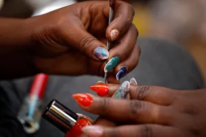A woman gets a manicure at a street stand in Port-au-Prince A woman gets a manicure at a street stand in Port-au-Prince