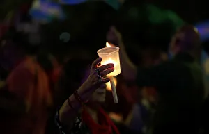 A woman holds a candle during a protest against utility rate hikes in Buenos Aires A woman holds a candle during a protest against utility rate hikes in Buenos Aires