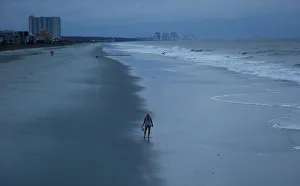 A woman looks for shells ahead of the arrival of Hurricane Florence in Surfside Beach A woman looks for shells ahead of the arrival of Hurricane Florence in Surfside Beach