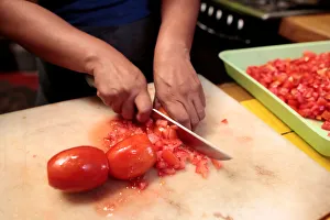 A woman prepares tomato sauce in her kitchen at the colonial city of Granada, Nicaragua A woman prepares tomato sauce in her kitchen at the colonial city of Granada, Nicaragua