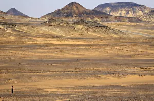 A woman walks through the Black Desert near the Bahariya Oasis southwest of Cairo A woman walks through the Black Desert near the Bahariya Oasis southwest of Cairo