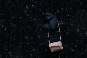 A woman walks through falling snow in Belfast