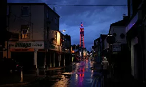 Images Dated 22nd September 2013: A woman walks down a side road towards the Tower in Blackpool