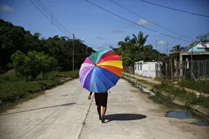 Woman walks along a street in El Yagual in the state of Apure Woman walks along a street in El Yagual in the state of Apure